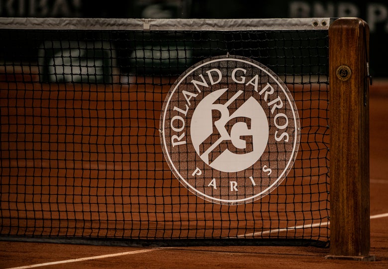 Image of the French Open logo on a net. 