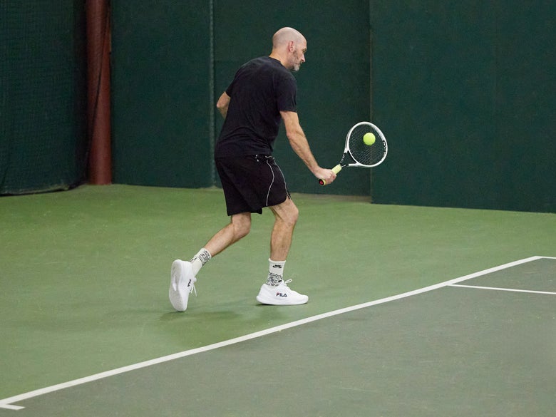 Playtester hitting a backhand drop shot