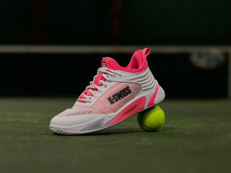 White/Pink KSwiss Hypercourt Pinnacle sitting on a tennis ball