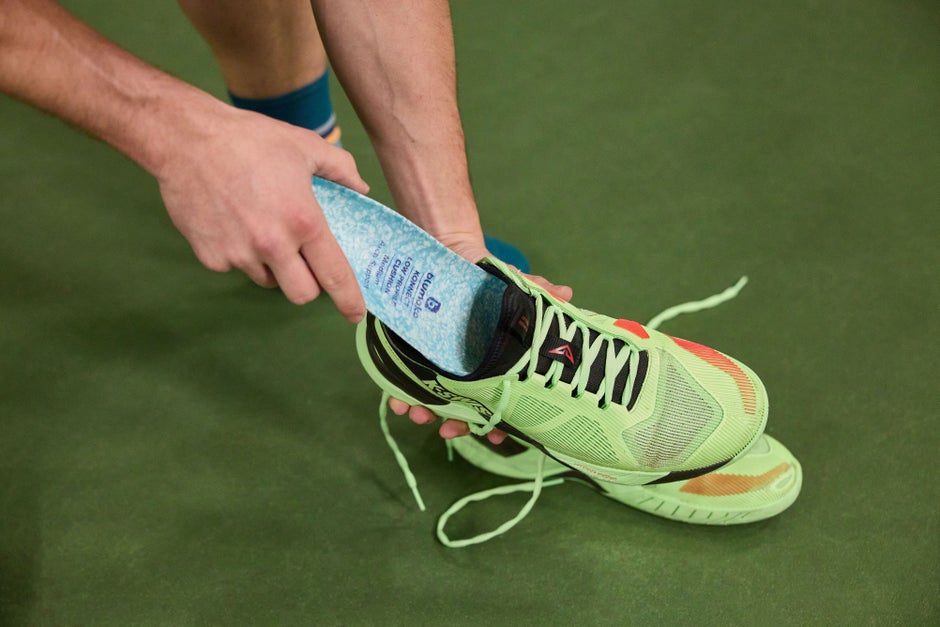 Blumaka insole being inserted into a shoe. 