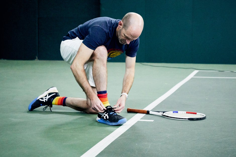 Playtester tying their shoes during a video shoot.