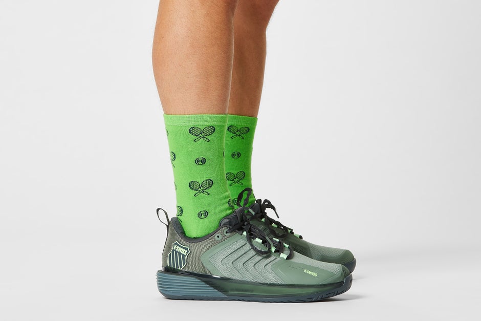 Green socks with tennis graphics and green shoes. 