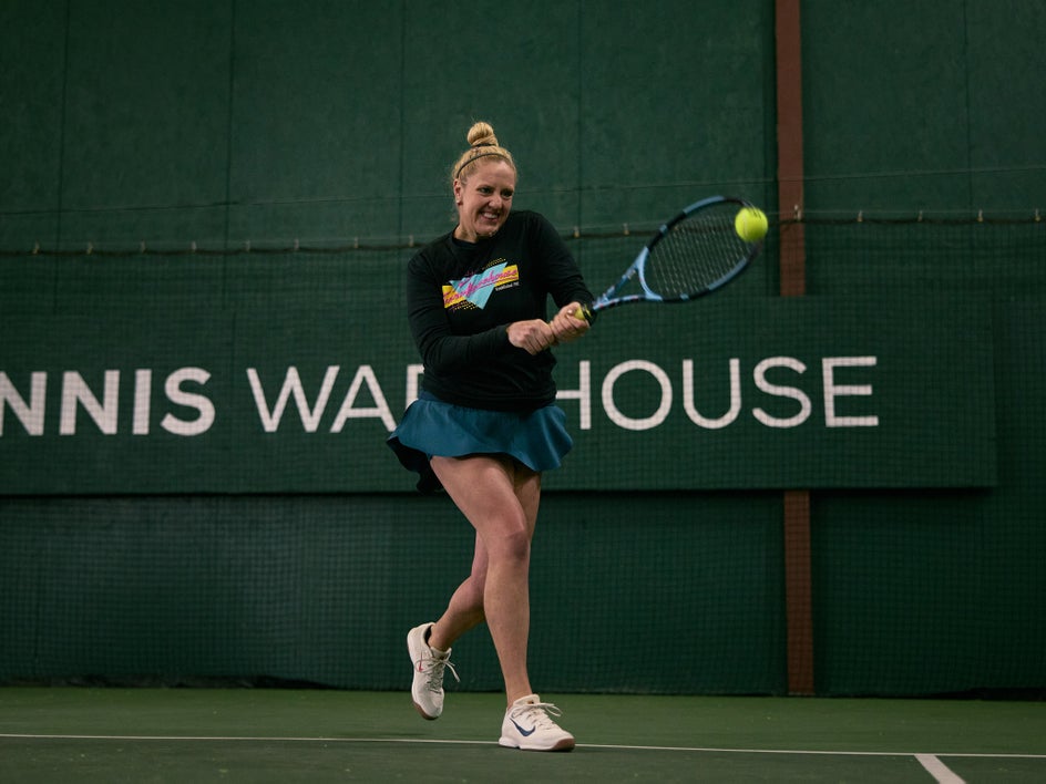 Playtester hitting a two-handed backhand
