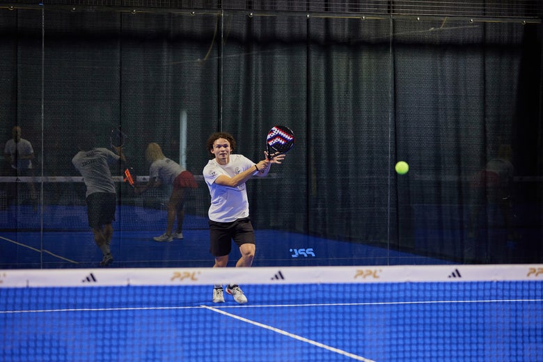 A round padel racket in action.