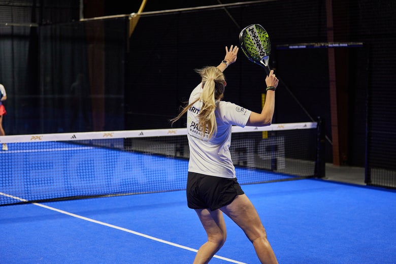 Image of a Padel Warehouse player hitting a smash from the left side.