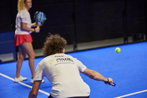 Image of a Padel Warehouse player defending on the right side.