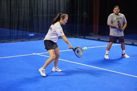 Image of a Padel Warehouse player defending on the right side.