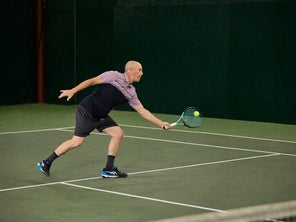Playtester hitting a forehand volley