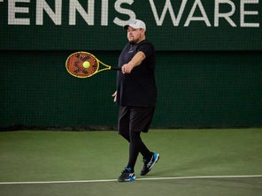 Playtester hitting a one-handed backhand