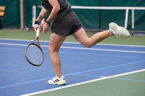 Image of a Playtester Hitting a Serve Focusing on Legs