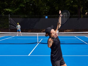 Image of a TW playtester hitting a serve.