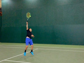 Image of playtester hitting a serve