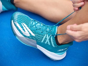 Image of a Closeup of a Player Tying Their Shoe